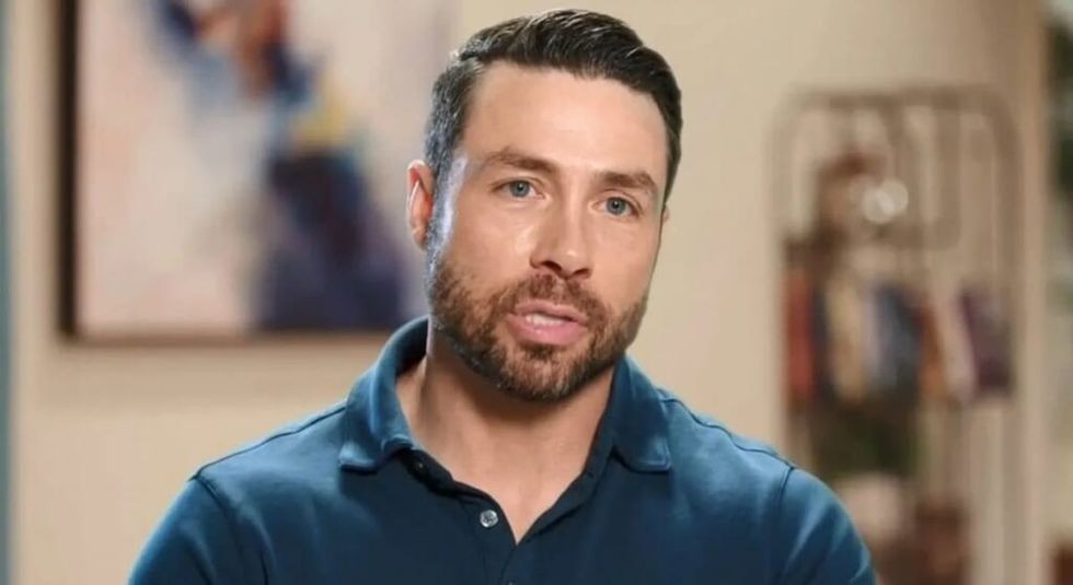 Geoffrey Paschel wearing blue shirt during interview.