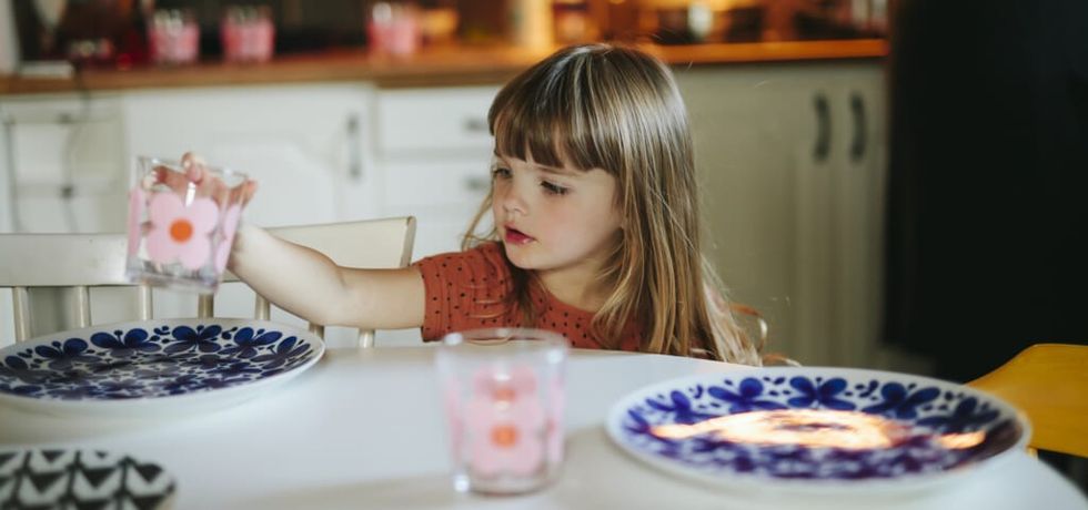 Girl setting table
