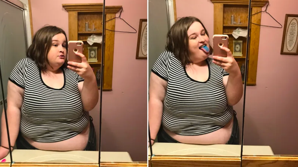 girl wearing a striped crop top and taking a photo in the mirror