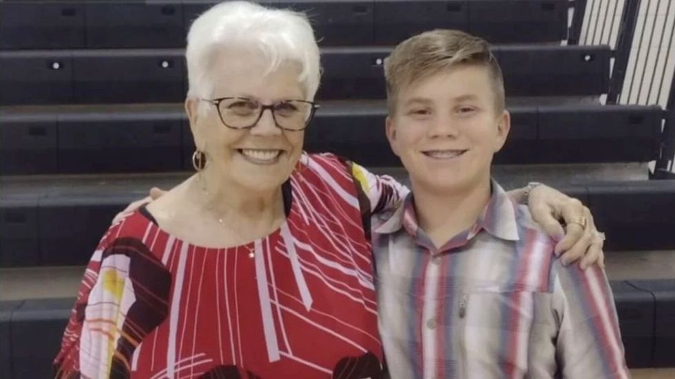 grandmother standing with a young boy