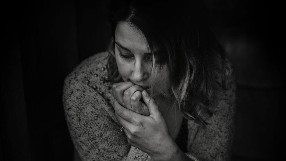 greyscale photo of woman wearing a long sleeve top