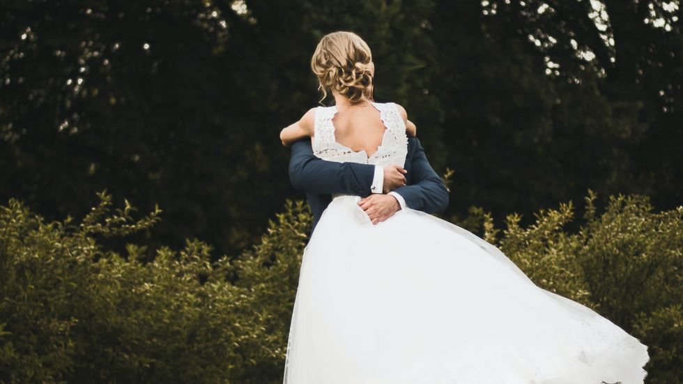 groom lifting his bride
