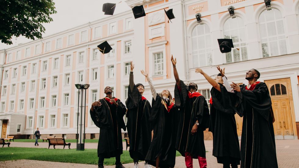 Group of friends throwing graduation caps in the air by Rut Miit on Unsplash