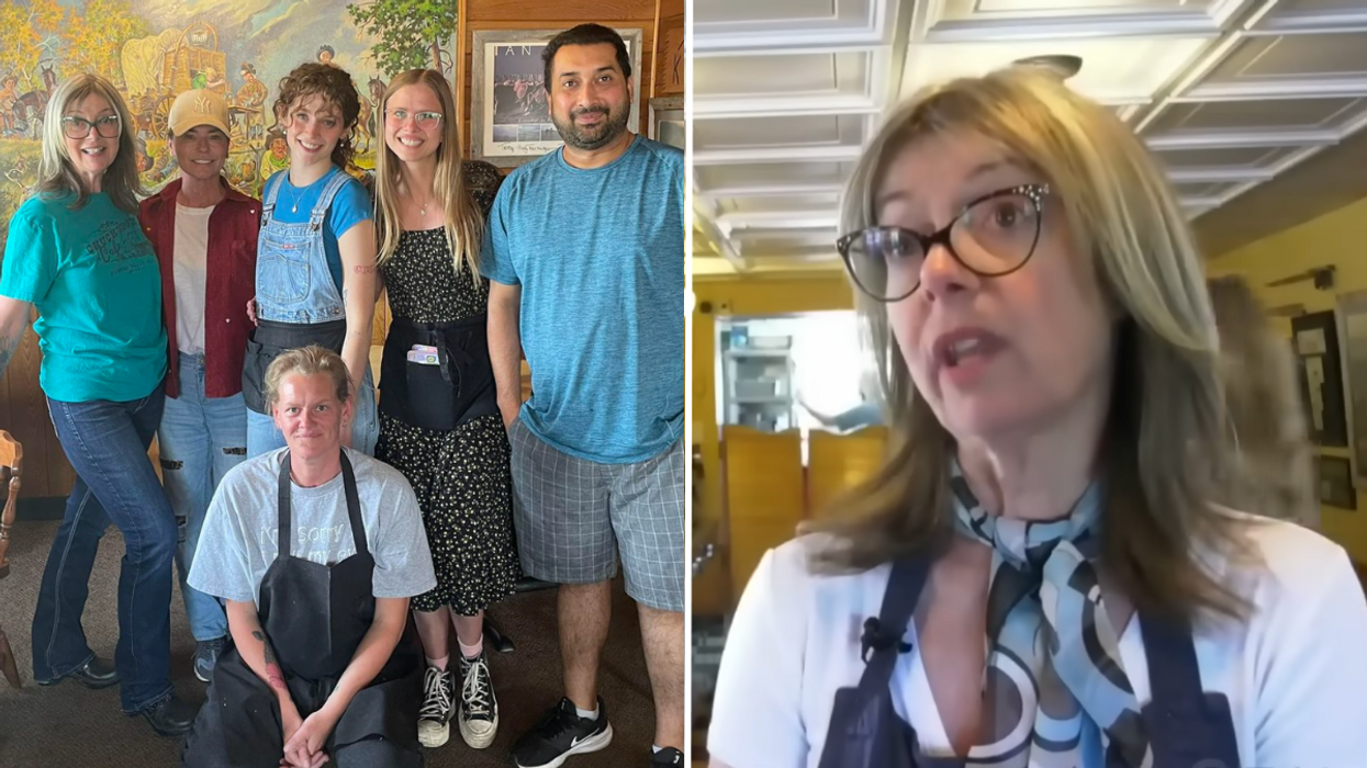Group of people posing for a photo in a restaurant and a woman wearing glasses.