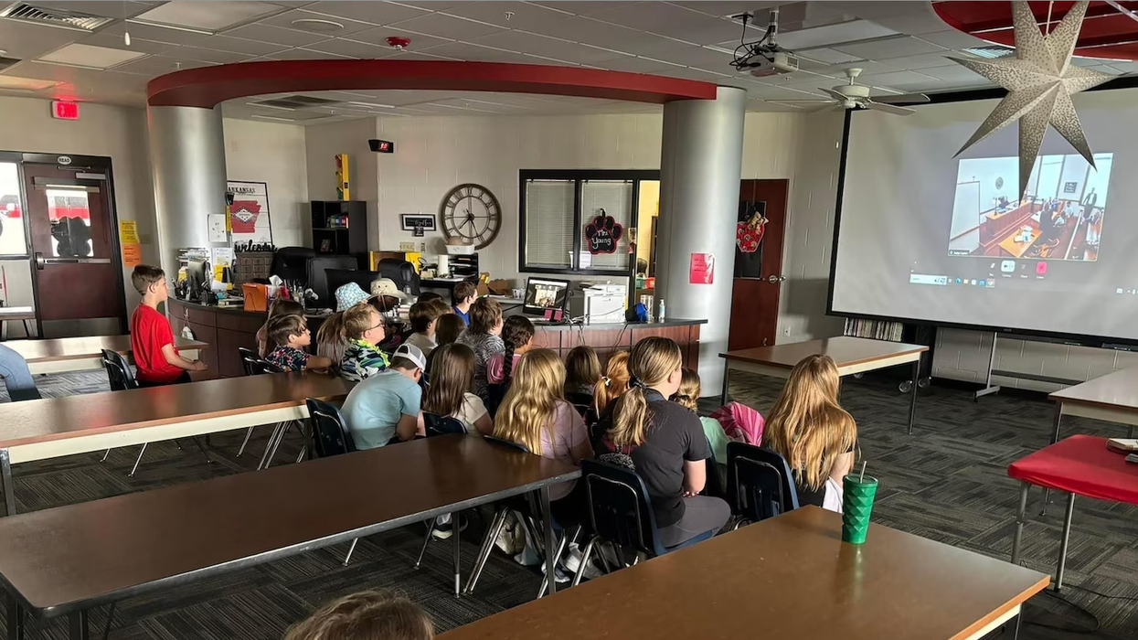 Group of people sitting together and watching a livestream.