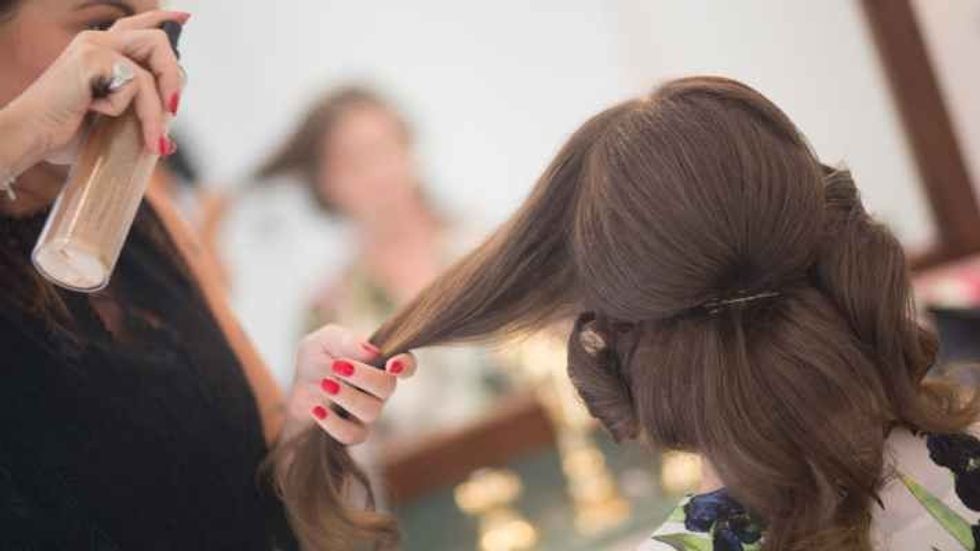 hairstylist working on a woman's hair