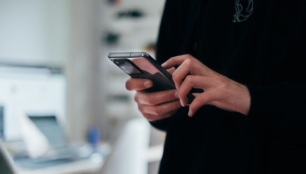 hand holding a phone indoors