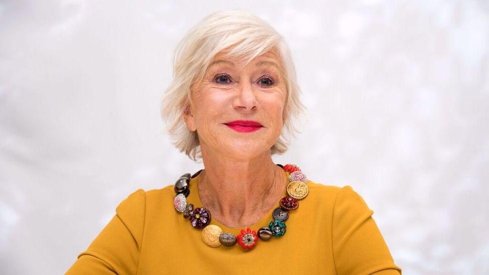 Helen Mirren smiling in yellow top