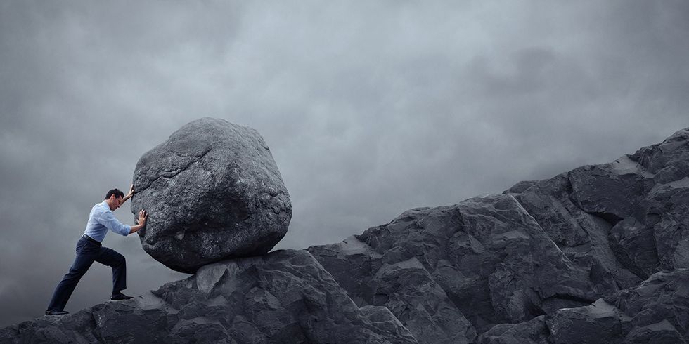 How to Get the Hard Things Done Without The Struggle - Man Pushing Boulder