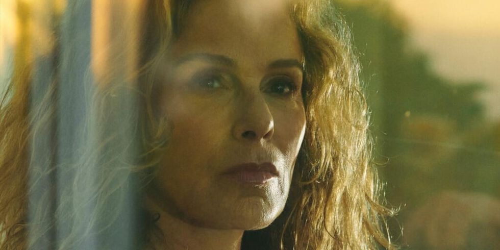 Jennifer Grey pensive looking out window