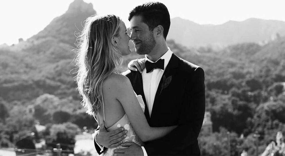 Josh Peck and Paige O'Brien in black and white wedding photo holding each other.