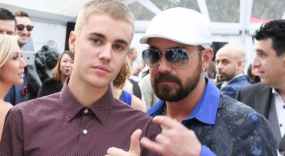 Justin Bieber wearing red button down shirt with dad Jeremy.
