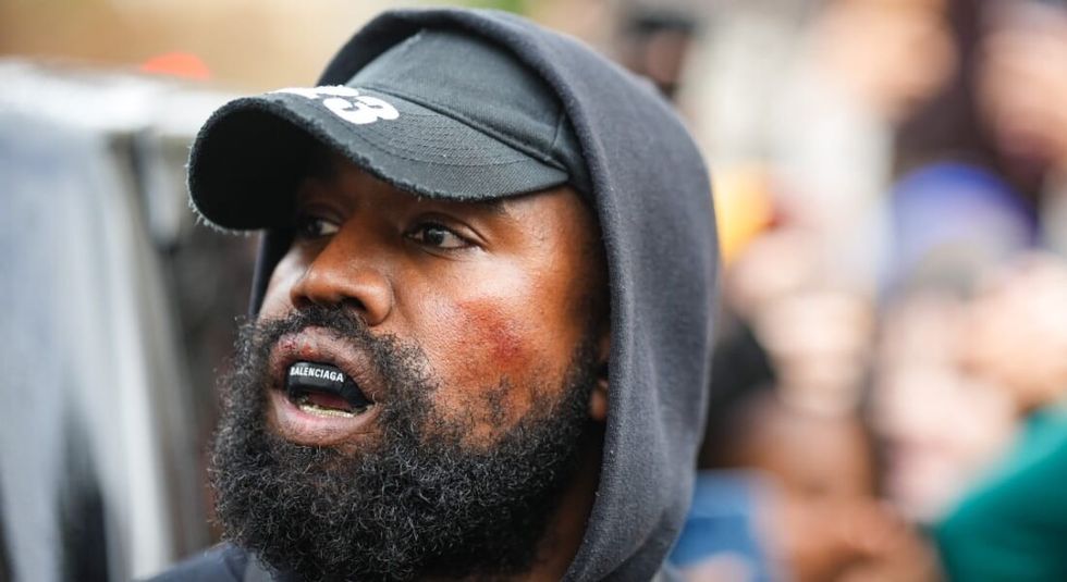 Kanye West in black hat during Paris Fashion week.