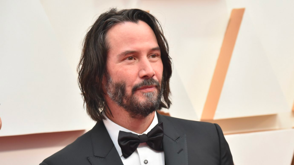 Keanu Reeves wearing a suit and bowtie.