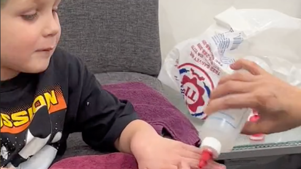 little boy getting his nails done