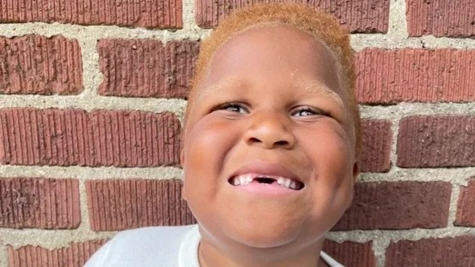 little boy with red hair smiling