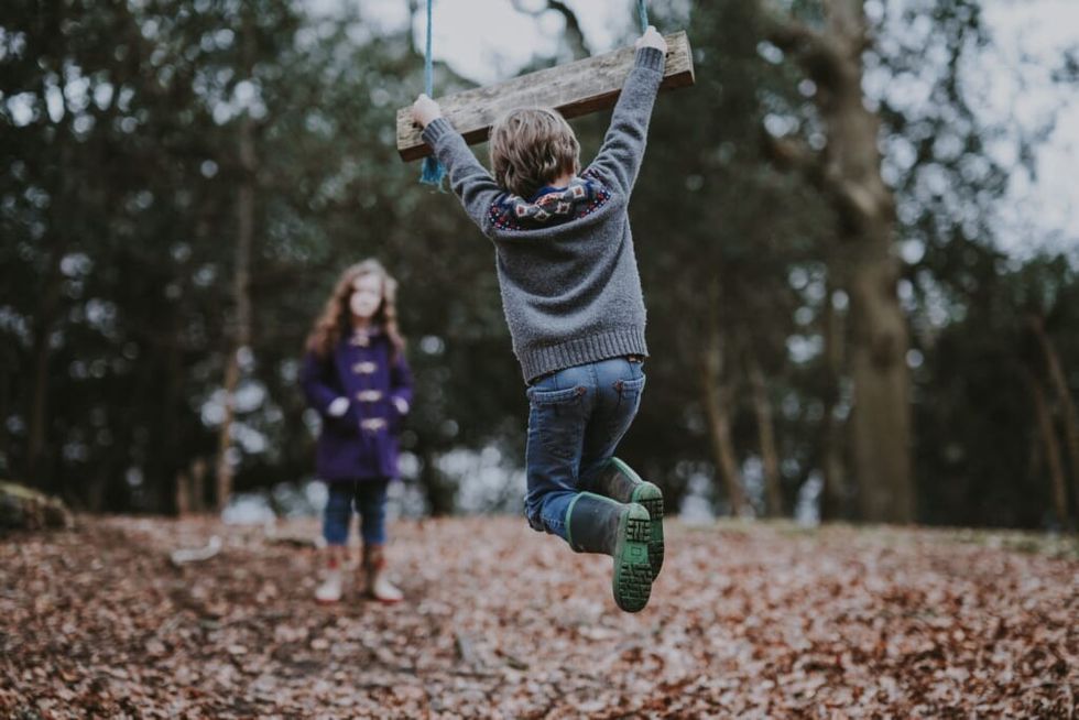 little girl and boy playing outside