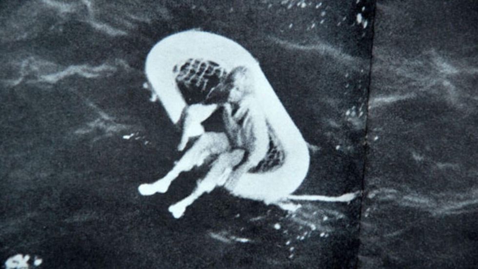 little girl floating on a small boat in the sea