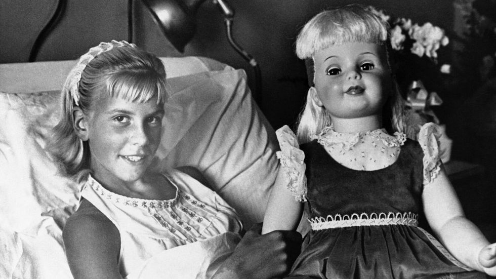 little girl holding a doll in her hands