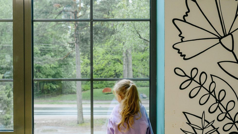little girl looking out of a window
