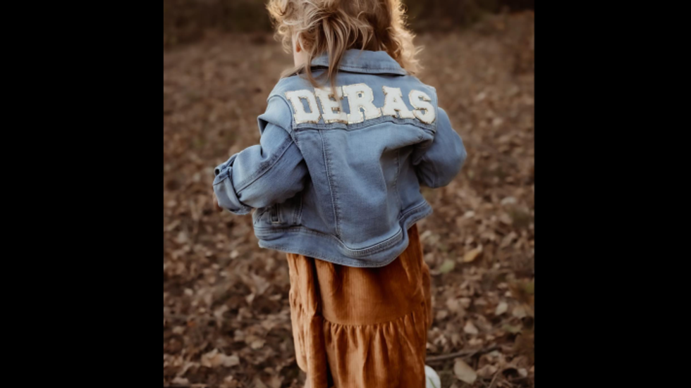 little girl wearing a denim jacket