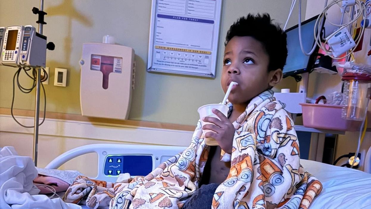 Little kid sipping a drink.