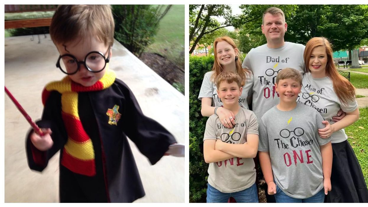 Little kid wearing red and yellow scarf and holding a wand and a five people posing for a picture.