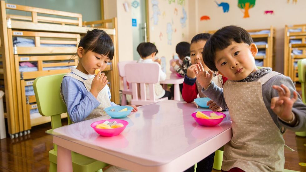little kids sitting at a desk