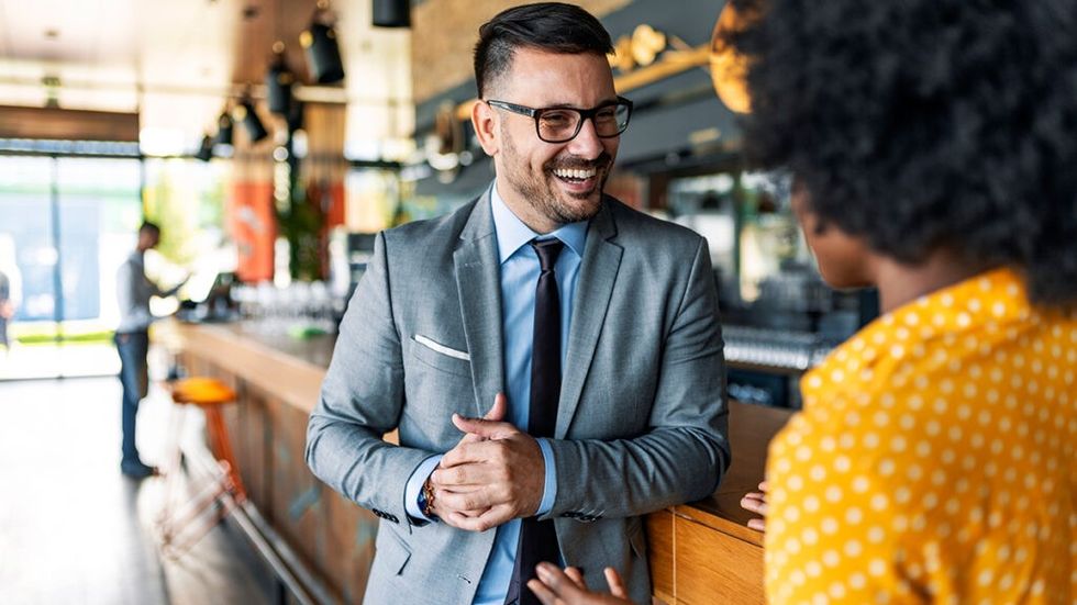 Man and woman talking at a bar