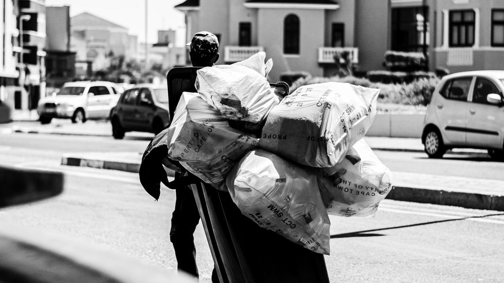 man carrying plastic bags