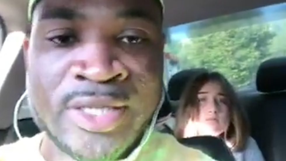 man driving with a young girl in the backseat