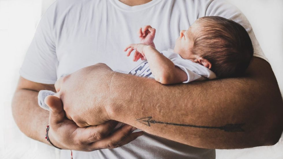 man holding a baby in his arms