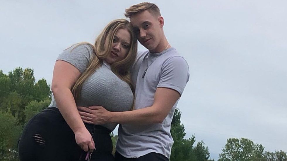 man hugging a woman wearing a grey shirt