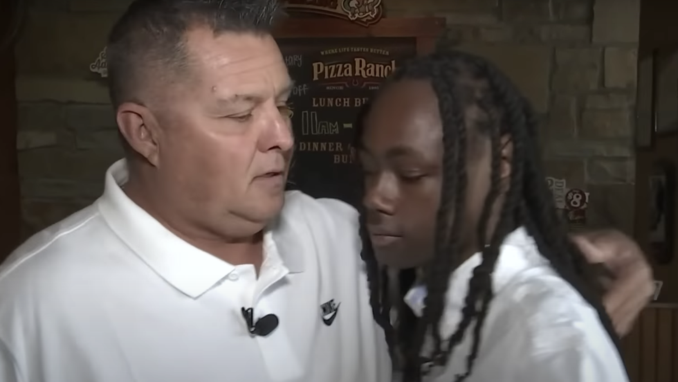 man hugging a young man