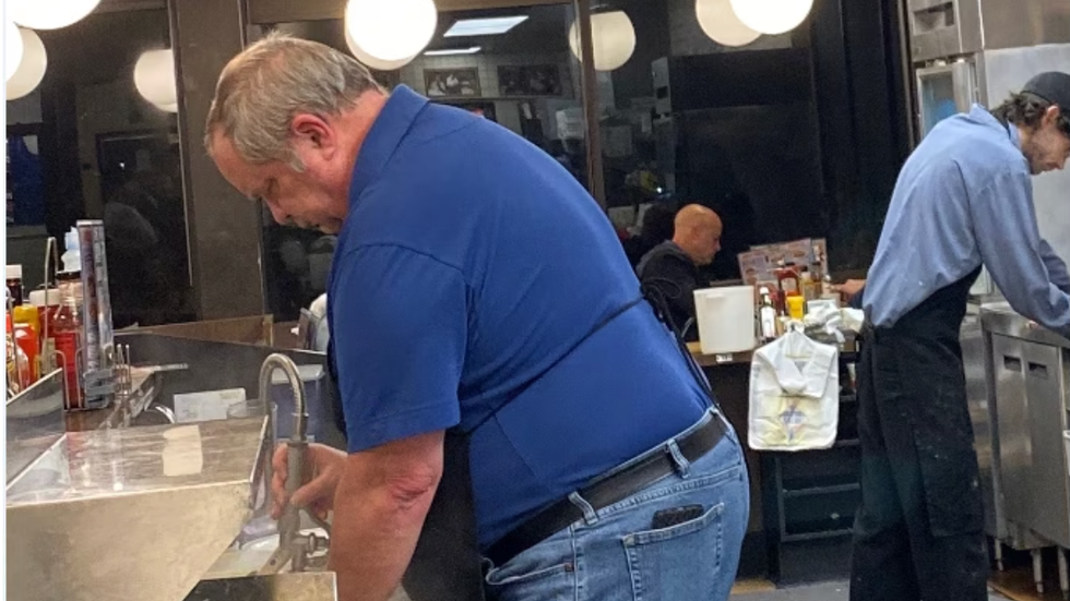 man in blue shirt working