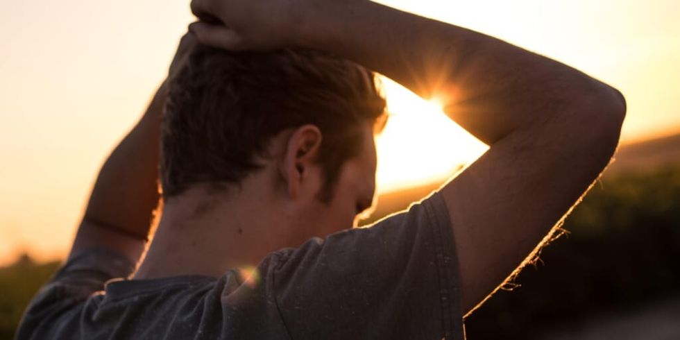 Man pensive holding head at sunset by Jeremy Perkins on Unsplash