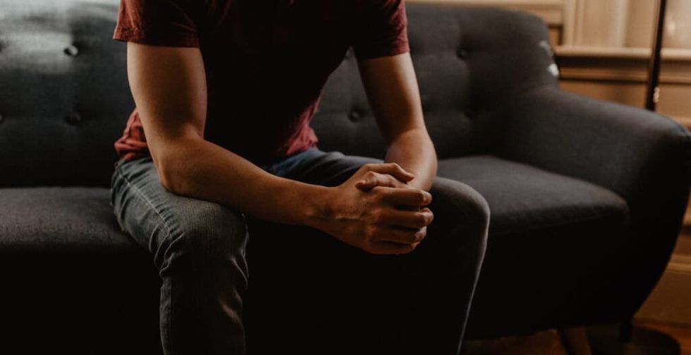 man's hands on therapist couch