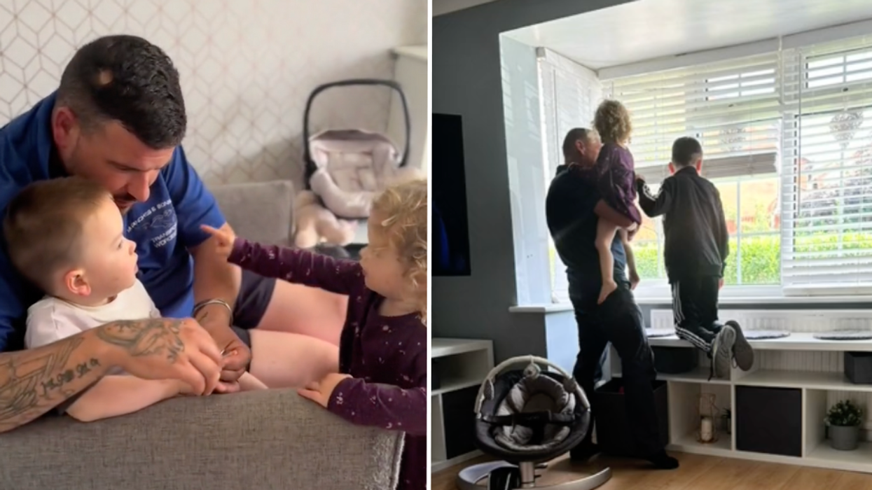 Man sitting on the couch with two kids and a man looking out of the window with two children.