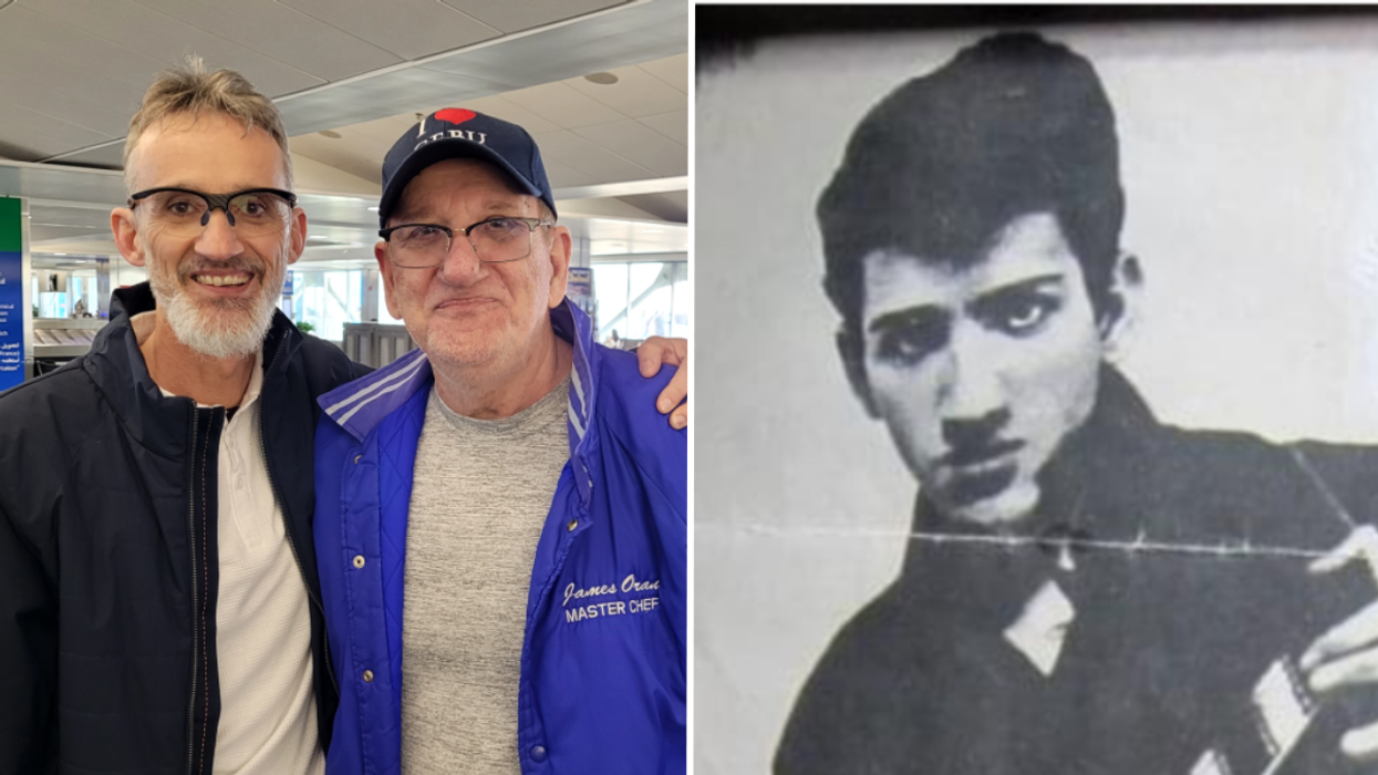 Man standing with his arm around his biological father and a black and white picture of a young man.