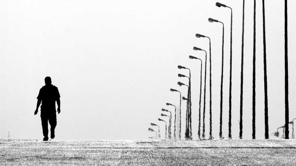 man walking alone on the road