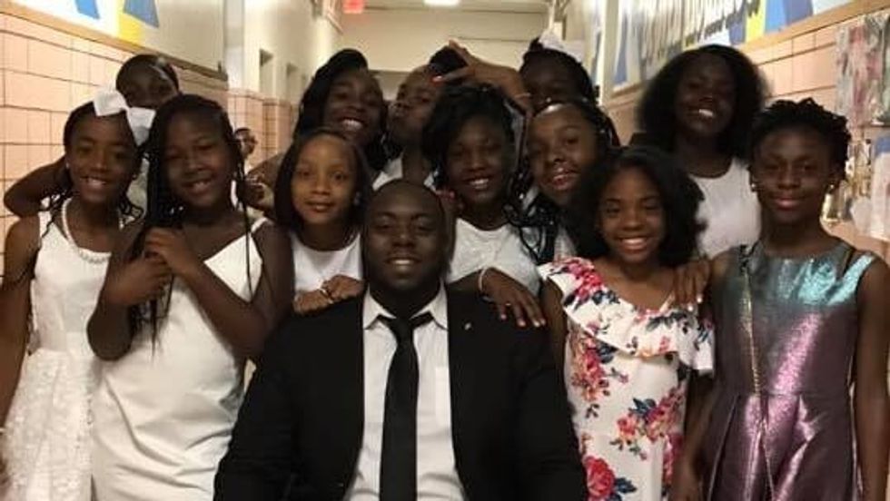 man with a bunch of kids standing around him