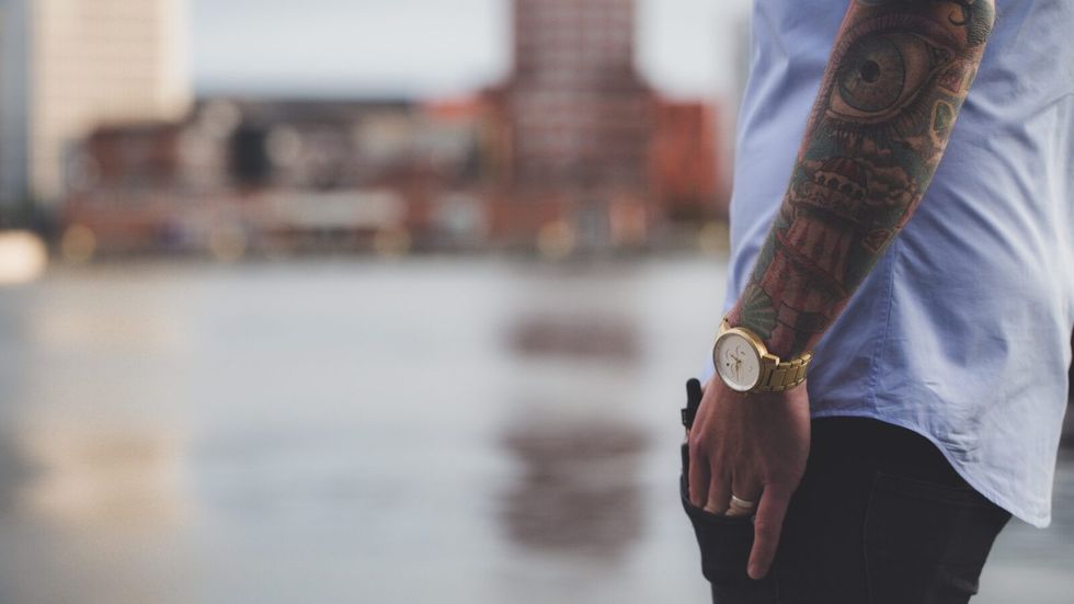 man with an arm tattoo