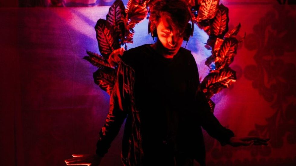 Man with headphones on red floral background