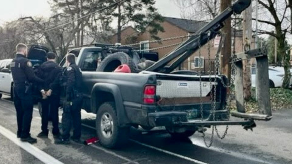 men standing near a tow truck