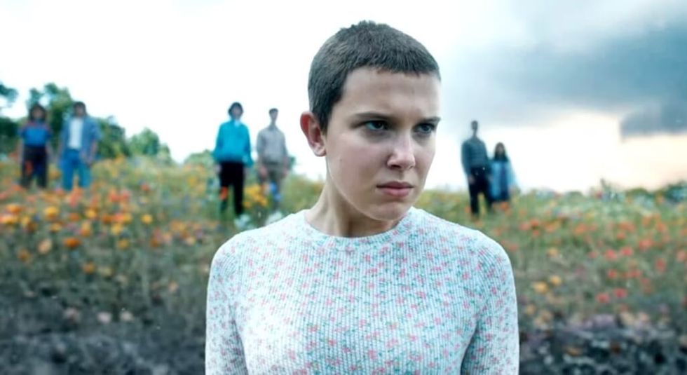 Millie Bobby Brown in white shirt and shaved head in Stranger Things 4.