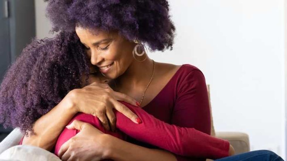 mom hugging her daughter
