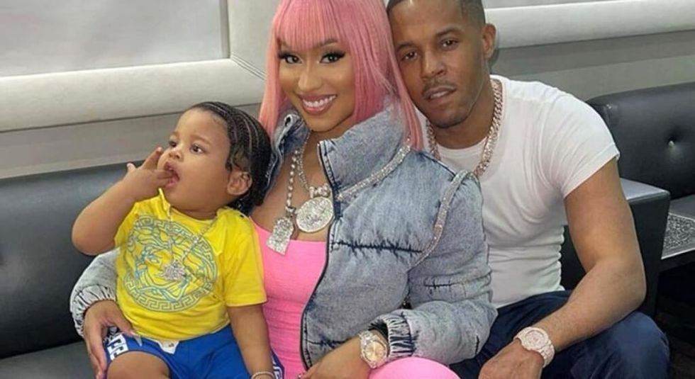 Nicki Minaj in pink hair holding her son with Kenneth Perry.