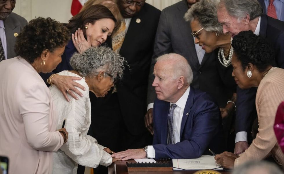 Ninety-four-year-old activist and retired educator Opal Lee, known as the Grandmother of Juneteenth, speaks with U.S. President Joe Biden after he signed the Juneteenth National Independence Day Act into law in the East Room of the White House