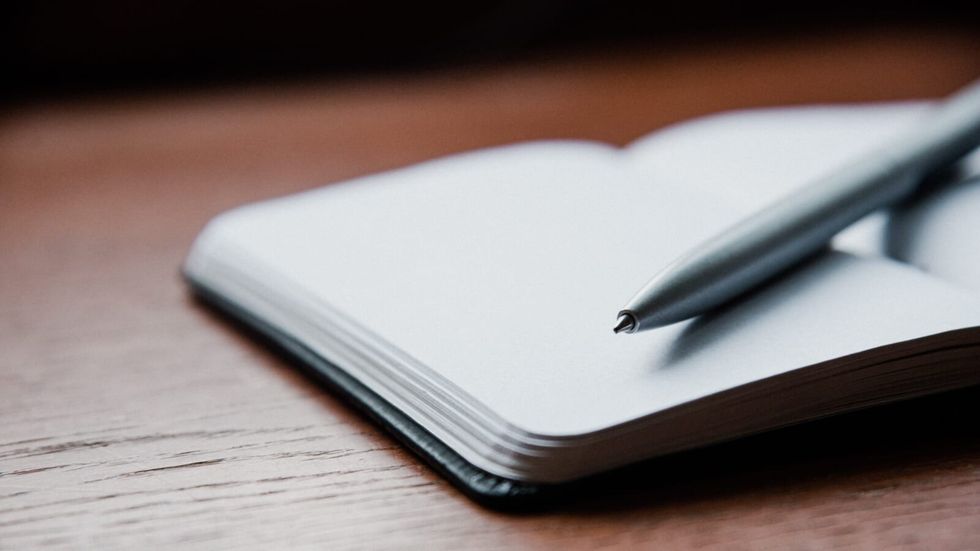 open journal with pen placed on it