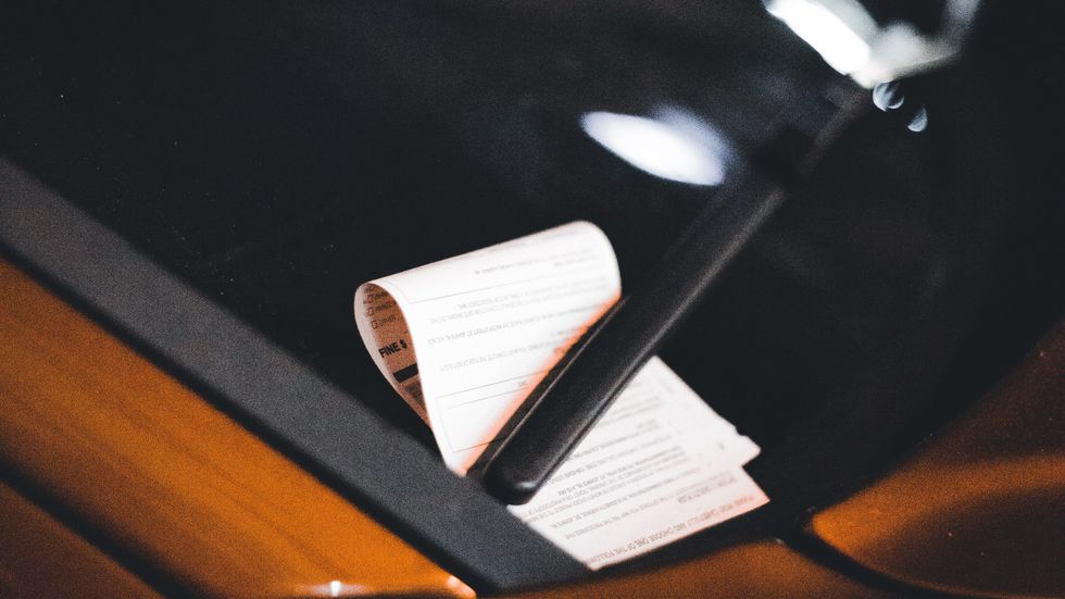 parking ticket on a car's windshield